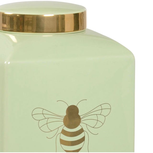 A small version of a traditional ceramic ginger jar by Wildwood Home in pistachio green, featuring a royal bee in metallic...