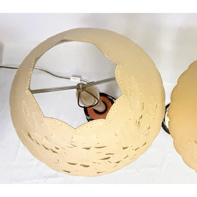 Pretty little Italian candlestick lamps. Made of ceramic in the Majolica style with raised floral and vine details on an...