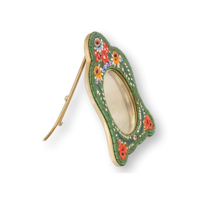 A striking Italian micromosaic picture frame, hand-set with jewel-toned glass tesserae arranged in bold floral motifs...