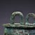 Impressive archaic-style bronze tripod ding vessel. Raised twin upright handles sit atop the wide rim. The rounded body is...