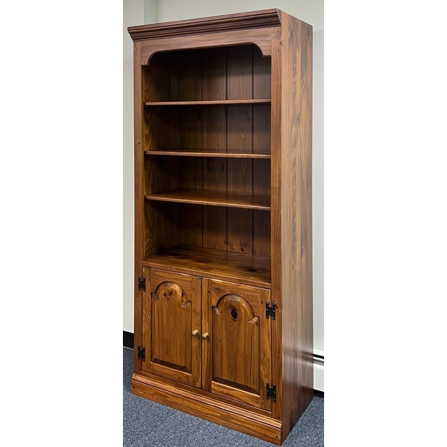 Farmhouse style pine bookcase by Ethan Allen from their Country Craftsman collection. Upper section features one fixed top...
