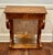 An elegant antique Biedermeier console table dating to the early 19th century, distinguished by richly figured walnut and...