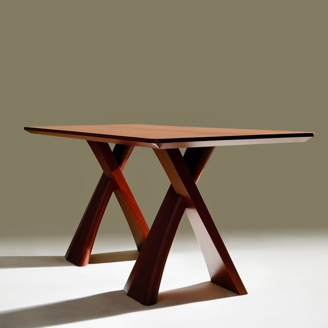 This striking, modern dining table is defined by its sculptural X-form base and clean, minimalist top. The top features a...