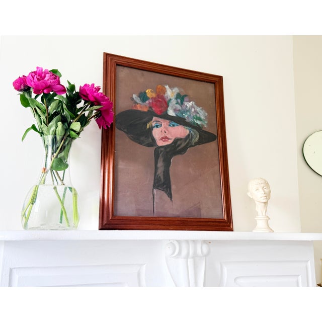 Vintage unsigned pastel portrait depicting a glamorous woman in an oversized black hat adorned with a vibrant floral...