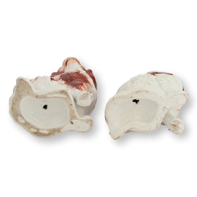 Mid 19th century pair of English Staffordshire King Charles dogs featuring classic hand-painted decoration and traditional...