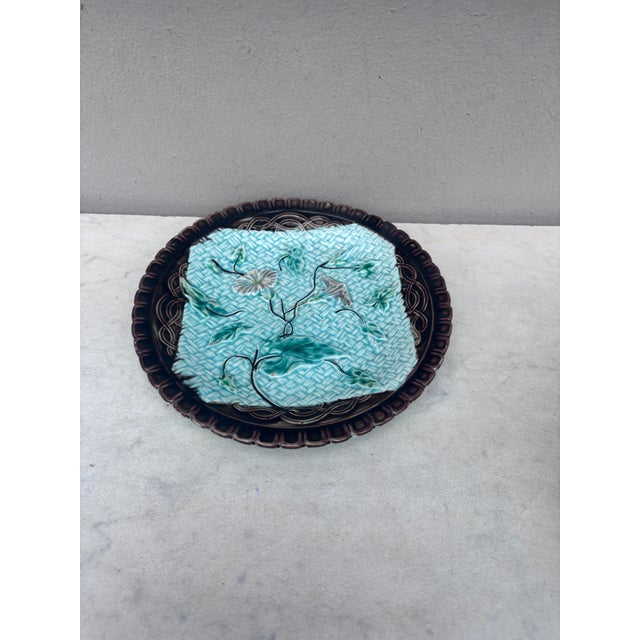 German Majolica plate with morning glory on a blue basket weave and a brown border, circa 1900.