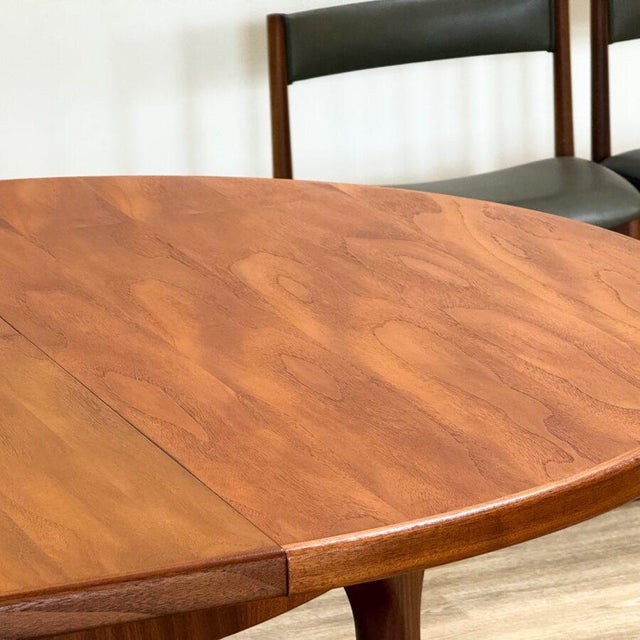 A refined expression of mid-century craftsmanship, this round extending dining table with four chairs was designed by Tom...