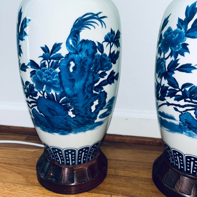 Large Gorgeous Pair of Classic Chinoiserie Lamps with Hand-painted Cobalt Blue Floral and Avian Motifs atop Carved Teak...