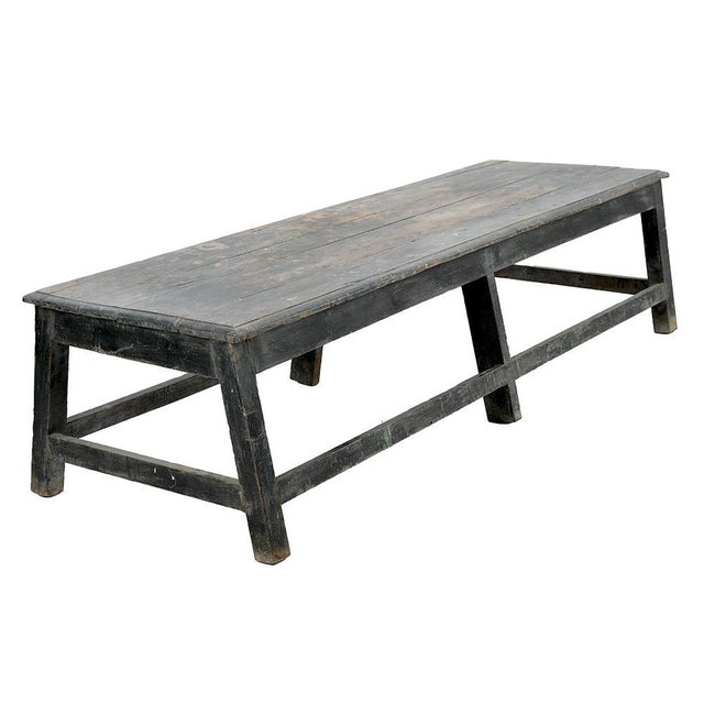 This antique solid wood bench sports a magnificent aged black patina, testifying to its history and authentic charm. with...