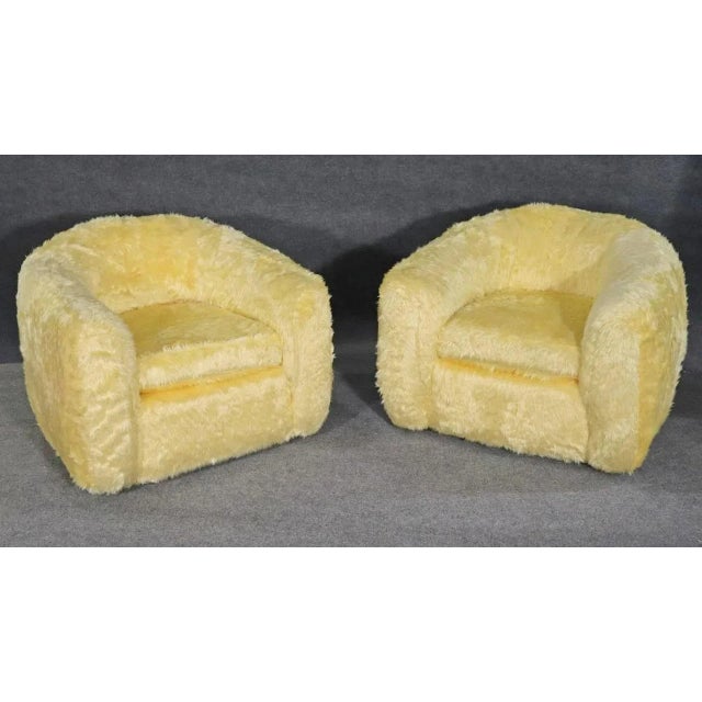 Pair of unique mid-century club chairs with faux fur covering. Soft and plush for home or office use. Please confirm...