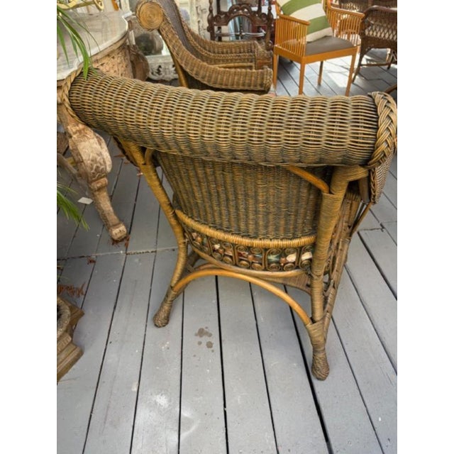 The product is a set of two fully assembled 1980s custom wicker porch chairs, designed in a brown color and suitable for...