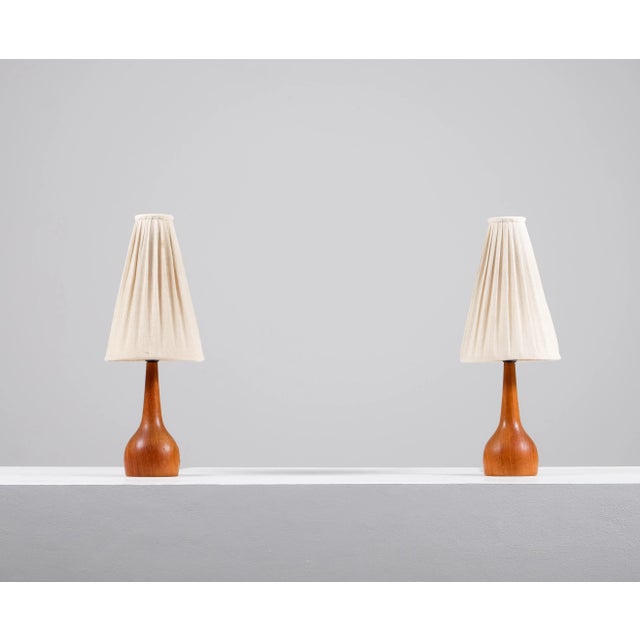 Pair of teak table lamps produced in Sweden during the 1960s. Up to 250V (Europe/UK Standard).The wiring of this item may...