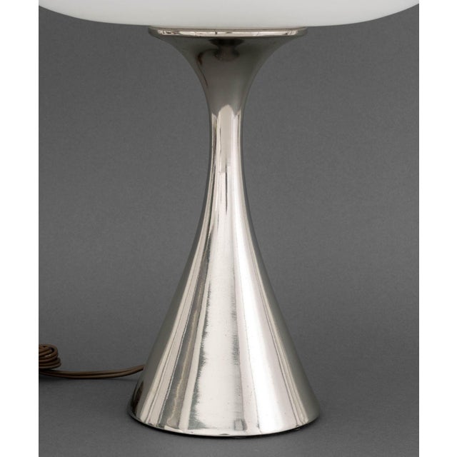 Laurel Mid-Century Modern Mushroom Table Lamp, with frosted white glass shade above an hourglass form chrome-plated base....