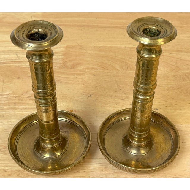 Pair of Russian Empire Brass Candlesticks with Drip Basins, circa 1790–1835 A substantial and finely proportioned pair of...
