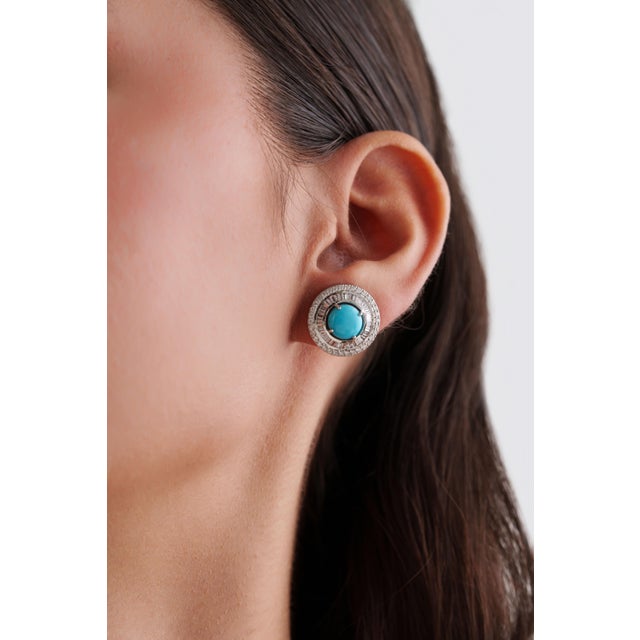These stud earrings feature 3.14 carats of natural round turquoise, set in 14K white gold. Each cabochons round turquoise...