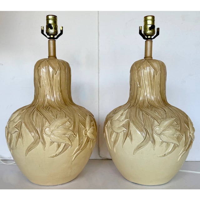 Pair of extremely chic vintage plaster table lamps in an Art Nouveau style. Made in the 1960s. They feature an elongated...