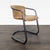This lounge chair features a sturdy black metal frame with a curved base for stability and modern style. The seat and...