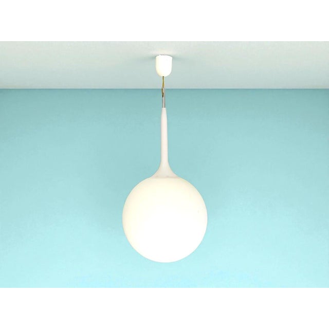 Castore lamp was designed by michele de lucchi for artemide. a spherical-shaped diffuser hand-blown in opaque white glass...