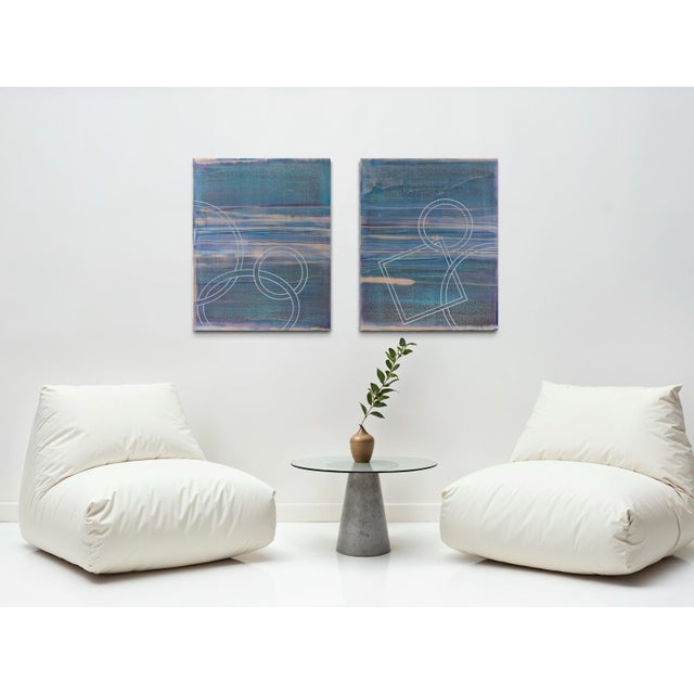 A deep, moody blue-green fills this two-panel diptych, overlaid with faint interlocking circles and angular line work that...