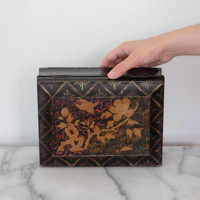 Antique Japanese black lacquer Meiji period box. There is a beautiful hand-painted scenic detail on the top of the box.