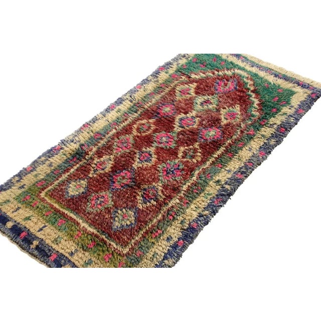 Hand-knotted in lush, quality wool circa 1950-1960, this 3x5 Turkish vintage Tulu rug enjoys the ruggedness of nomadic...