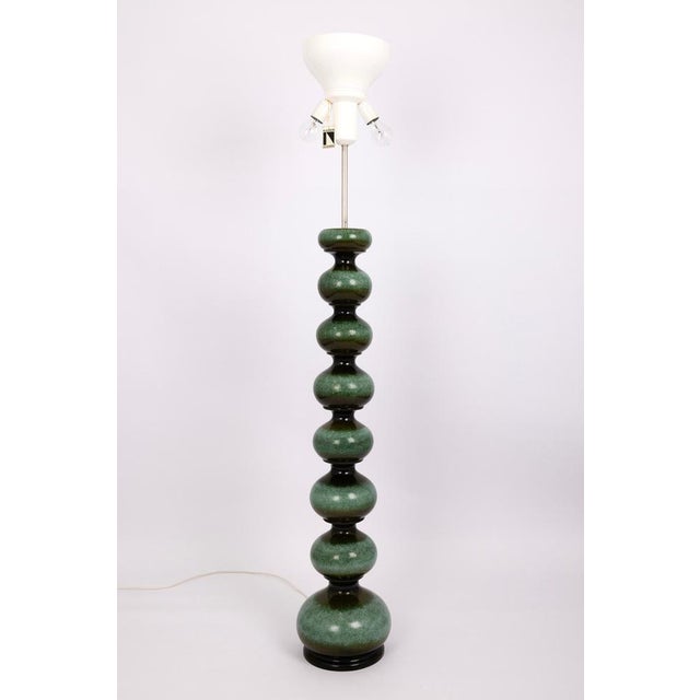 An exceptional large-scale table lamp designed by kaiser in germany in the 1970s. The sculptural base, composed of stacked...