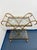 This stunning vintage Hollywood Regency two-tier bar cart features a gilt-finished metal frame with decorative scrollwork,...