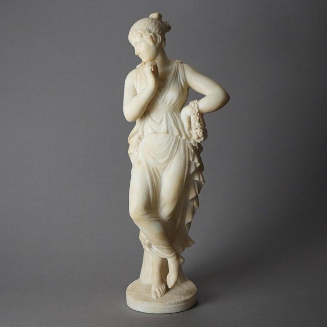 This alabaster sculpture by P. Bazzanti depicts a classical woman in a graceful pose. The sculpture showcases fine...