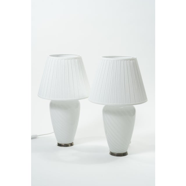 Italian Murano table lamp. The lamp is made of mouth-blown Murano glass with a delicately twisted optical pattern that...