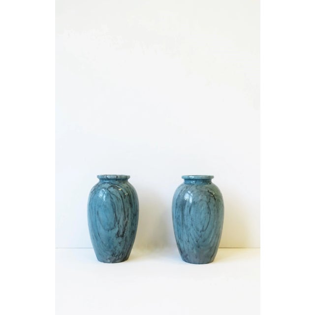 A beautiful and substantial pair of urn style blue marble vases, circa mid-20th century, Italy. Marble has black veining...