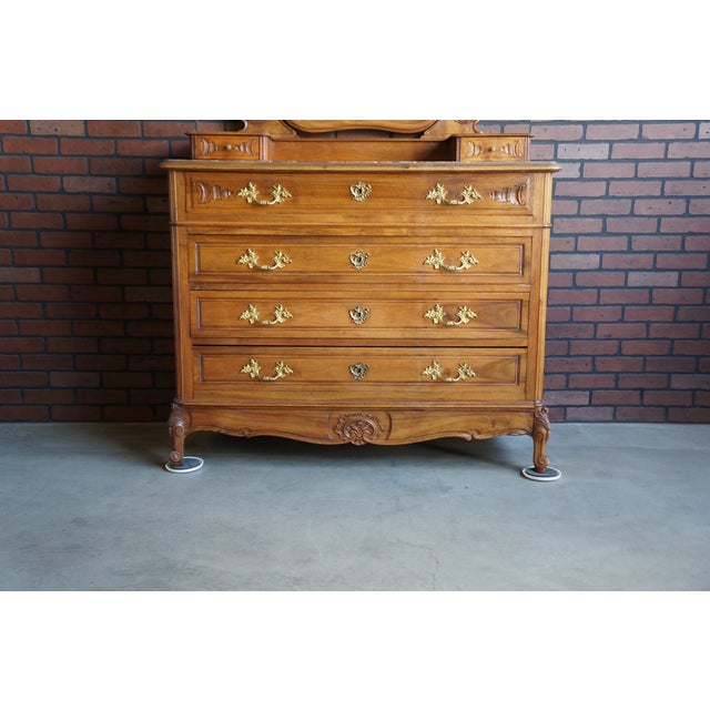Remarkable antique French Rococo tall chest of drawers with mirror. Featuring four drawers with period brass hardware and...