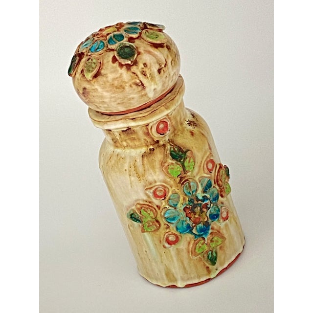 This pot is in Ceramic. The decorative Patterns are flowers in ceramic. It has been done in South of France, circa 1970.