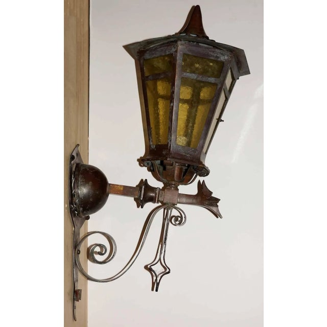 Exceptional pair of antique, early 20th century bronze, exterior wall-mounted lanterns of tapered hexagonal form, with...