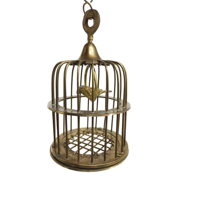 Embark on a journey into vintage charm with the beguiling allure of a Miniature Brass Birdcage, a treasure from...