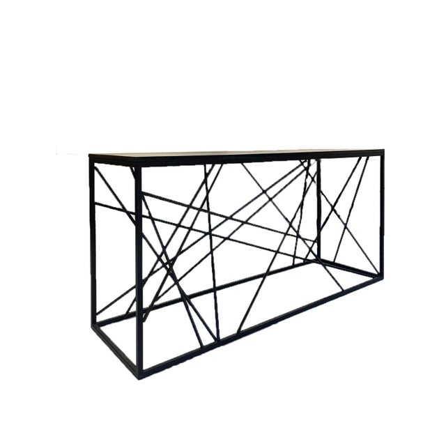 A study in structure and tension, the Tension Grid Console explores balance through intersecting steel lines contained...