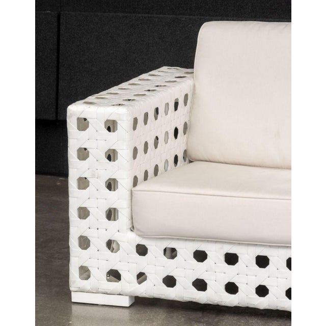 Skyline Design Three-Seat Sofa, woven white plastic framed with beige cushions. 36" H x 95" W x 36" D; seat: 17" H....