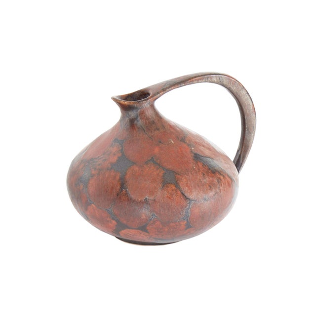 A West German ceramic pitcher designed by the German ceramicist Kurt Tschorner for Ruscha Keramik. This pitcher has a...