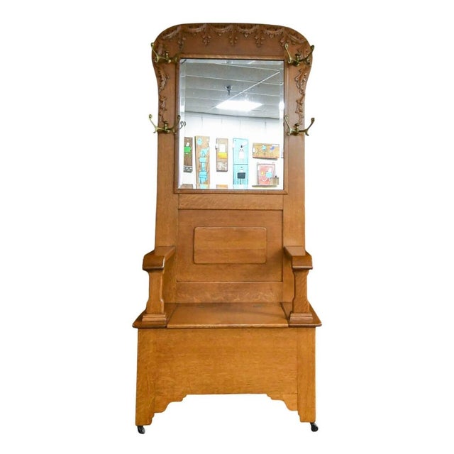 An Oak Coat Rack Bench features durable oak construction with a flat seating area and an integrated coat rack with hooks....