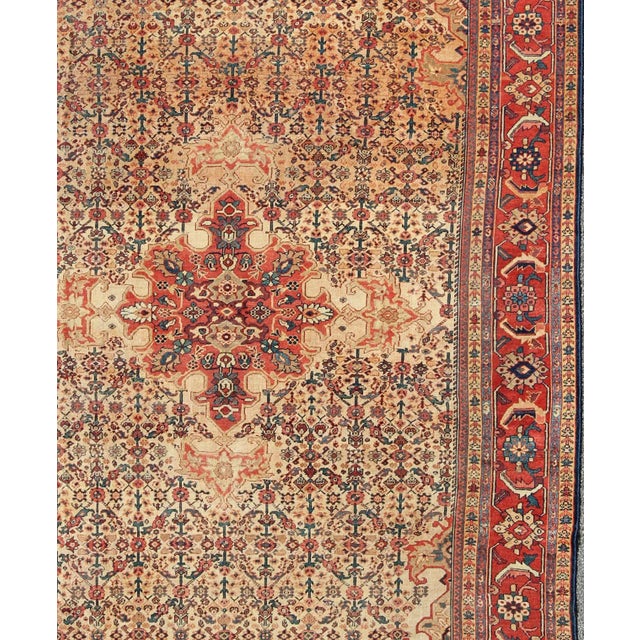 Antique Persian Sultanabad with Medallion in Yellow Cream, Blue Red and Green Measures: 8'10” x 12'4” Antique Persian...