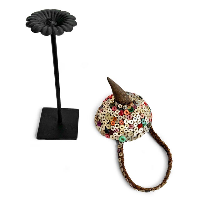 Original button-adorned sculptural hat referencing the ceremonial traditions of the Lega people of the Democratic Republic...