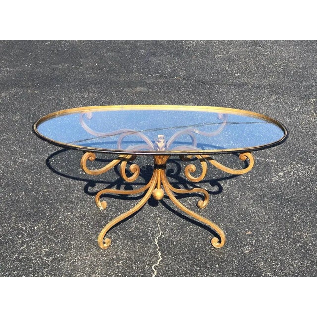 French style oval iron coffee table. Romantic scroll work and diminutive size make this table very feminine. Dimensions...