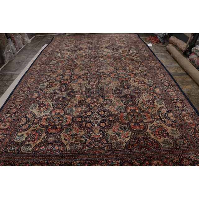 Hand knotted in wool originating circa 1890-1900, this 10x17 antique rug connotes an exceptionally rare Persian Bidjar rug...