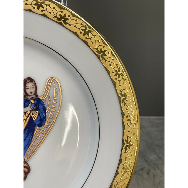 This plate is part of the Muirfield Holiday Plate collection - Celebrity 9408. Featuring a serene angel dressed in flowing...
