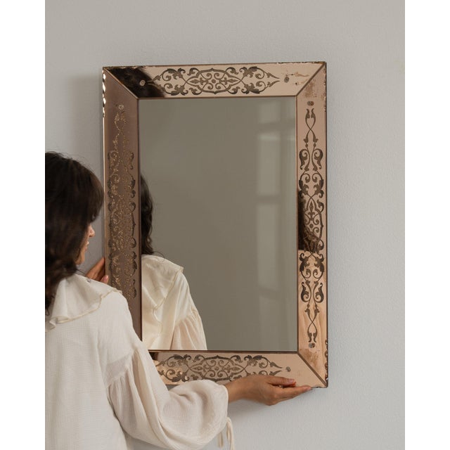 Carved wood mirror in Warm Blush Pink. The warm blush pink surface highlights fine relief-carved frame, soft blush-toned...