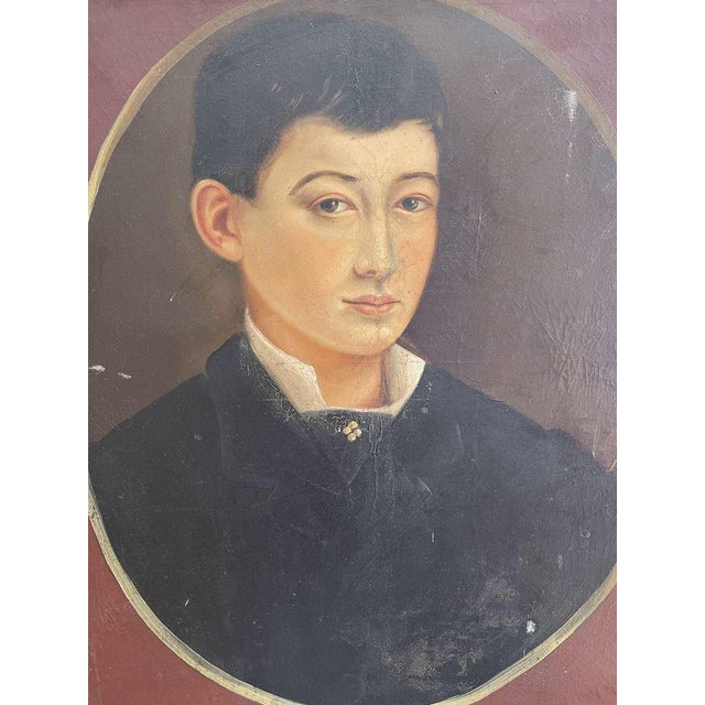 Oil painting on canvas depicting the portrait of a young boy in a medallion. Dimensions with frame - w 58,5 cm x h 71 cm...