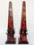 A pair of 20th Century obelisks with a bold brick-red and black faux shell veneer that covers all sides. Four ebonized...