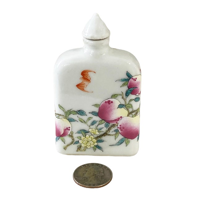 This Chinoiserie Famille Rose porcelain snuff bottle, measuring 3.5" high by 2.25" w by 0.75" D , is exquisitely painted...