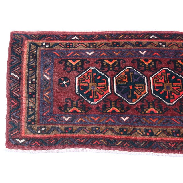 This vintage Turkoman rug show the artistry of Central Asian weaving traditions. Featuring three bold hexagonal medallions...