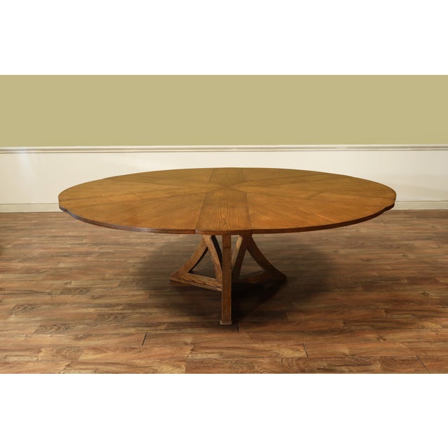 66-86 inch round jupe dining table in a golden oak or tobacco brown finish. The pedestal table opens from 66 inches to 86...