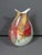 A substantial hand-blown art glass vase with a dramatic sculptural profile and vibrant Murano-inspired palette. The...